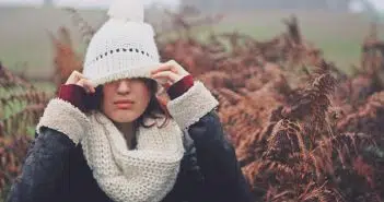 woman cover eye of knit cap