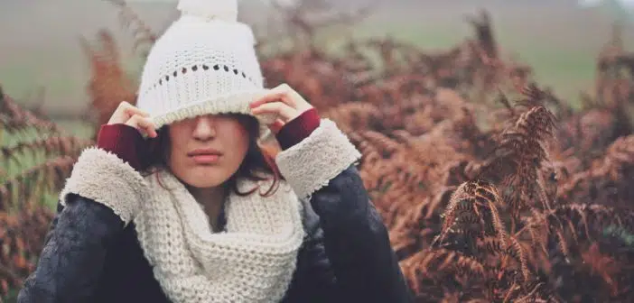 woman cover eye of knit cap