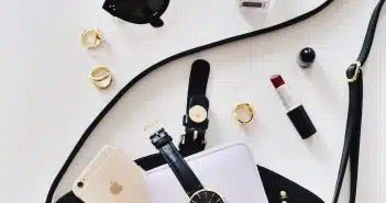 women's sunglasses and black bag with watch and iPhone 6